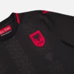 Albania national team third football jersey 2024/25, black with red accents and emblem.