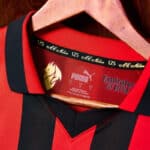 AC Milan football jersey with Puma logo and club crest, perfect for soccer fans and sportswear enthu.