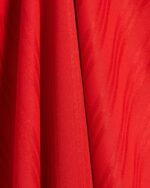 Red adidas Adicolor T-shirt fabric close-up.