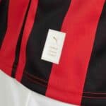 Authentic Puma AC Milan football jersey with red and black stripes.