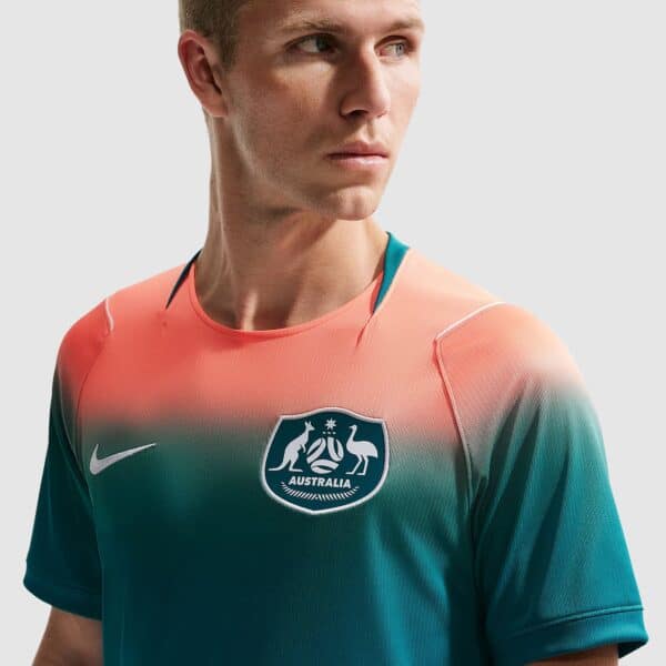 Close-up of a man in an Australia jersey, looking to the left.