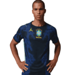 Man wearing a blue Brazil national soccer jersey, standing with hands on hips against a white background.