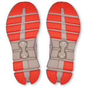 Bottom view of a pair of red running shoes with textured soles and gray midsole accents.