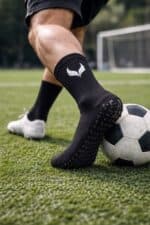 Anti-slip football socks with grip sole, arch support, and breathable fabric for enhanced performanc.