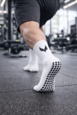 Anti-slip football socks with grip sole, arch support, and breathable fabric for enhanced performanc.