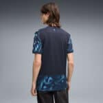 Back view of a man wearing a dark athletic jersey with blue marbled sleeves and hem.