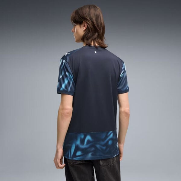 Back view of a man wearing a dark athletic jersey with blue marbled sleeves and hem.