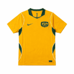 Yellow Australia soccer jersey with green side panels, green collar trim, Nike swoosh on the chest, and team crest on the left chest.