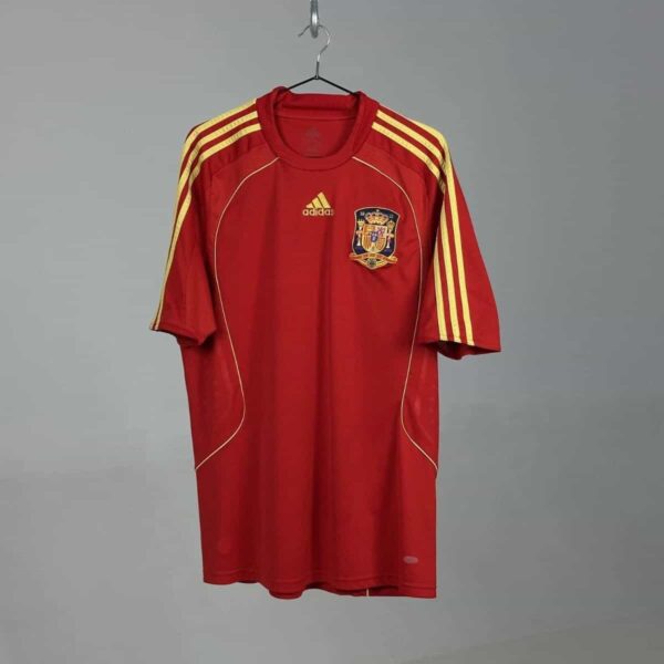 Official Spain national team home jersey 2008/10, red with yellow accents, Adidas logo, and team cre.