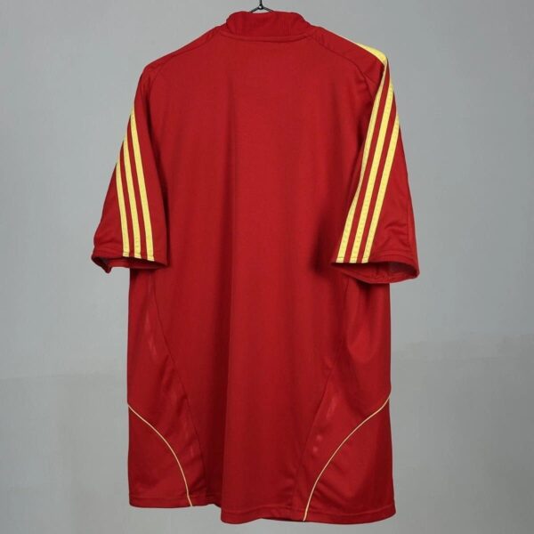 Spain national team home football jersey 2008/10, red with yellow stripes on sleeves.