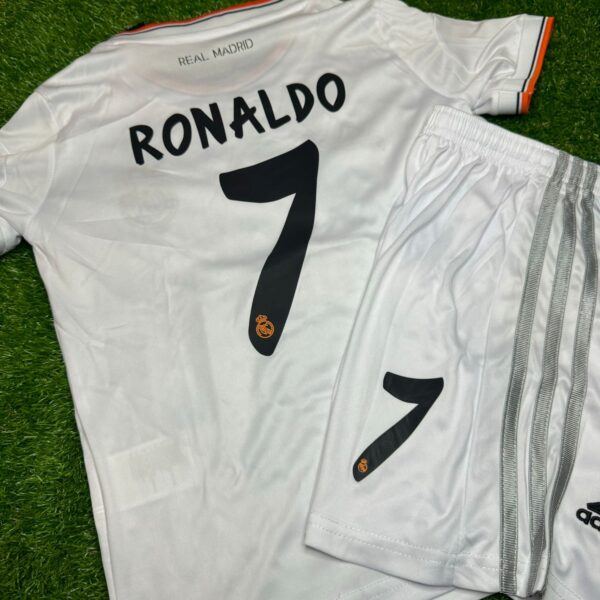 White Real Madrid soccer jersey laid on grass showing the back with the name RONALDO and the number 7.
