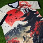 0009302_0 | UAE SPORT STORE Japan national football team jersey laid flat on grass with red and black wave-style artwork and team crest