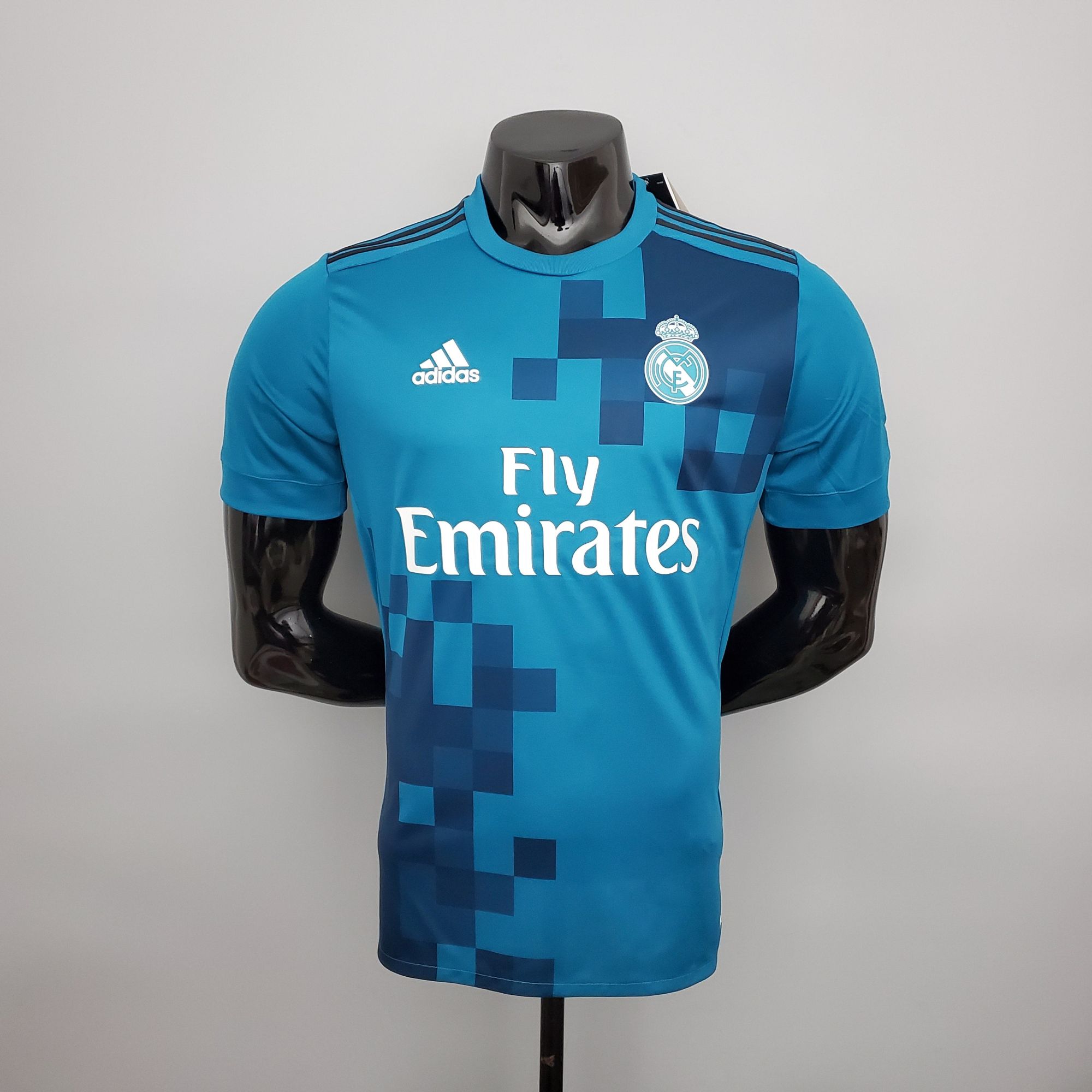009a0566_6b19e546-2432-4501-8336-b307b713708c | UAE SPORT STORE Blue Real Madrid jersey on a mannequin, showing the Adidas logo, club crest, and Fly Emirates sponsor.