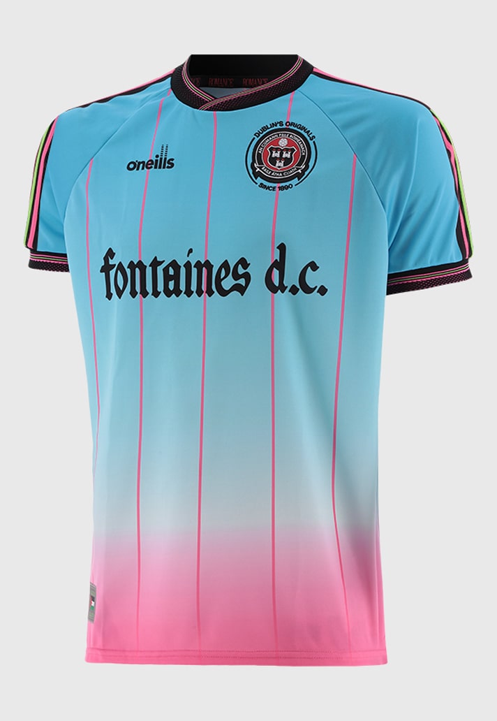 00A469D7-5523-4E43-A494-661921412247 | UAE SPORT STORE Light blue to pink gradient soccer jersey with pink vertical stripes, Fontaines D.C. sponsor text, and club crest on the chest.