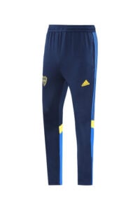 00d98b59 | UAE SPORT STORE Navy blue Adidas track pants with light blue side stripes and a yellow Adidas logo on the right thigh; features a shield crest on the left thigh.