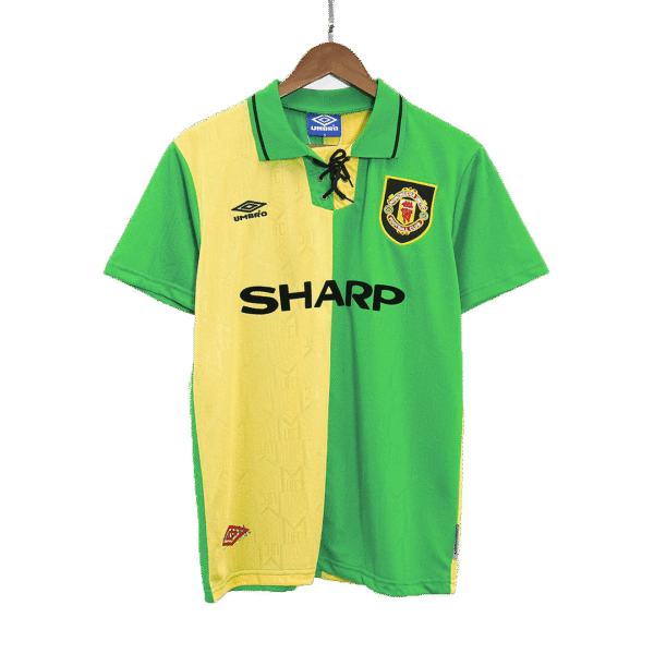 Green and yellow Arsenal-style soccer jersey on a hanger, featuring a crest, Umbro logo, and 'SHARP' sponsor across the front