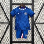 Chelsea football jersey on a wooden hanger against a metal grid background, featuring a white Nike swoosh and Chelsea crest on a blue kit with red/white trim.