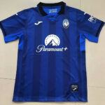 Front view of a blue striped soccer jersey with Paramount+ sponsor across the chest, team crest on the left chest, and Joma logo on the right.
