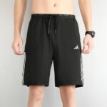 Men's black athletic shorts with white side stripes and drawstring waistband, mid-thigh length, Adidas logo on left leg, suitable for sports or workouts.
