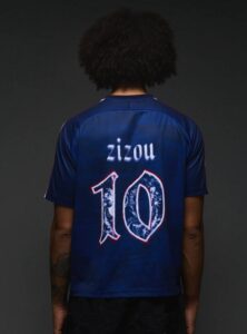 Back view of a person wearing a blue soccer jersey with the name 'zizou' and the number 10 on the back.