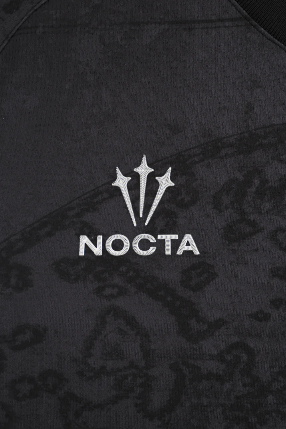 02_Home_Kit_Venezia | UAE SPORT STORE شعار Nocta الأبيض (ثلاث شوكات) مع كلمة NOCTA مطرزة على قماش داكن بنقشة