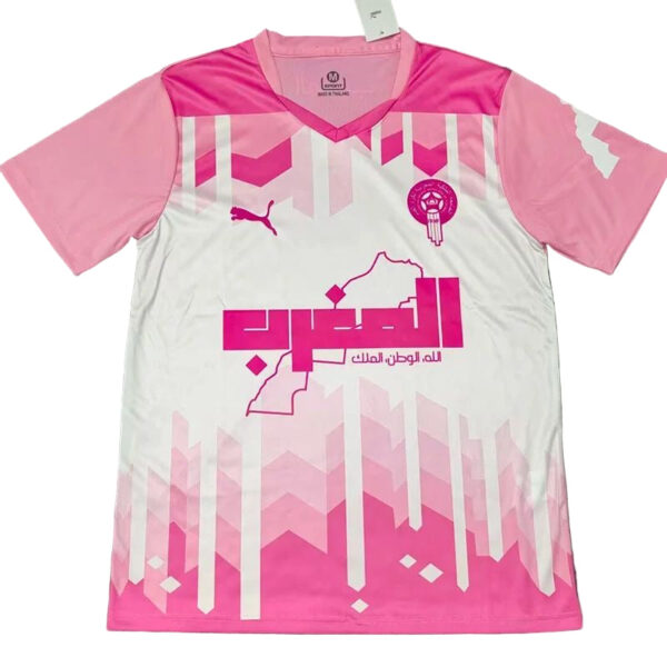 Pink and white soccer jersey featuring a geometric pink pattern, Puma logo, team crest, and Arabic sponsor text.