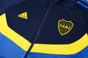 02f94540 | UAE SPORT STORE Navy and yellow Adidas jacket with the CABJ crest on the left chest.