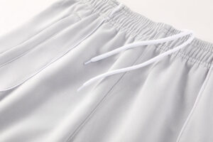 Light gray athletic pants with an elastic waistband and white drawstring