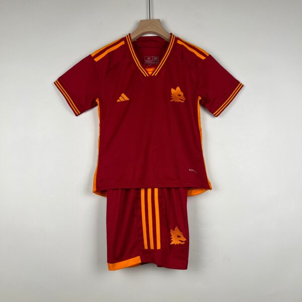 Maroon athletic jersey on a wooden hanger with orange stripes on the shoulders and sides, featuring a gold lion crest on the chest.