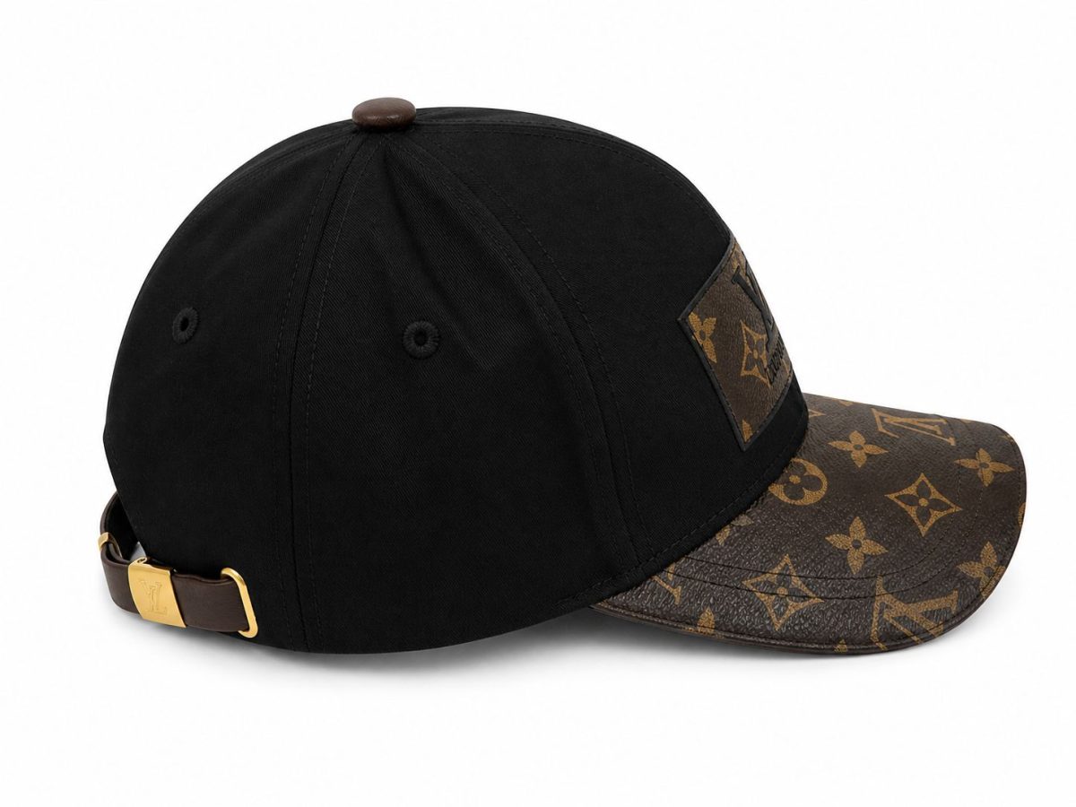 Black baseball cap with a brown LV monogrammed brim and adjustable strap at the back.