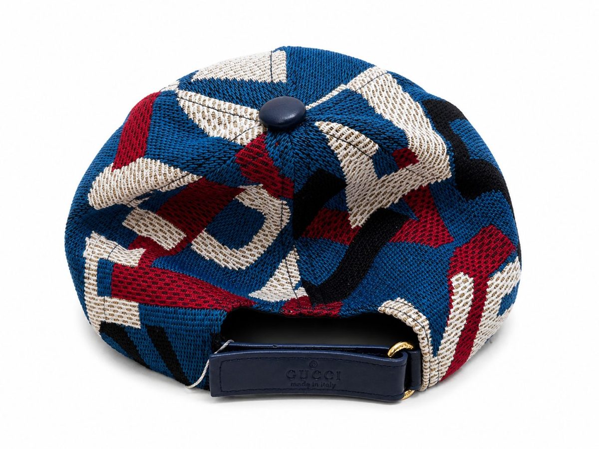 Back view of a blue, red, white geometric knit cap with a Gucci strap and gold hardware, made in Italy.