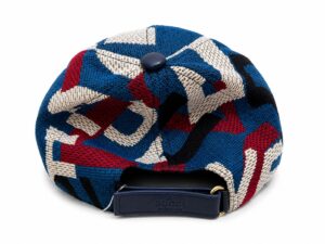 Back view of a blue, red, white geometric knit cap with a Gucci strap and gold hardware, made in Italy.