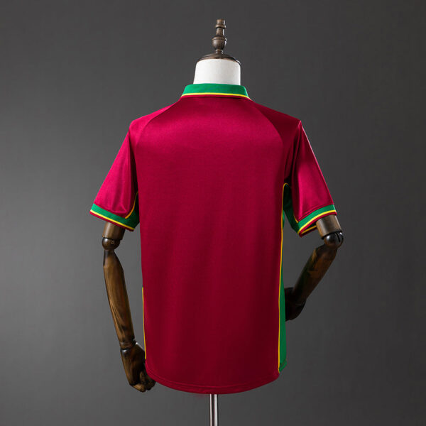 Back view of a maroon sports jersey on a mannequin, with green and yellow trim at the collar and sleeve cuffs.