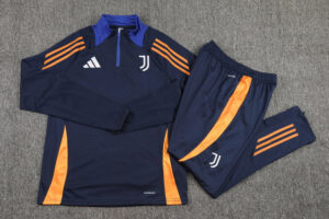 Navy Juventus training top and matching pants with orange panels, laid flat on a gray carpet.