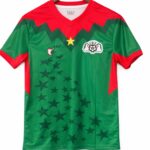 Green and red V-neck sports jersey on a wooden hanger, featuring a star pattern across the front and a crest on the chest.