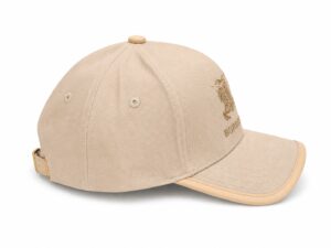 Beige Burberry baseball cap with an embroidered crest on the front and an adjustable strap at the back