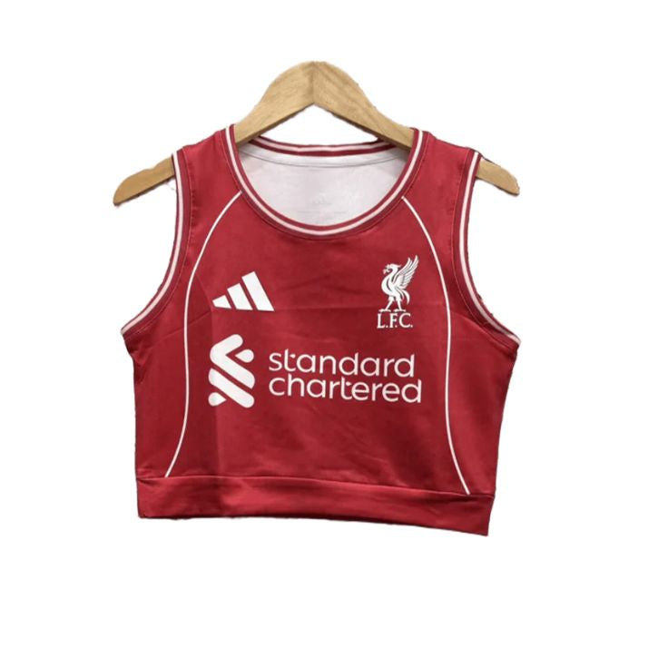 0618a790-a30c-4b82-95a9-266a31cddd05 Red cropped sleeveless football jersey with white piping, Liverpool FC crest, Adidas logo, and 'Standard Chartered' sponsor on a hanger