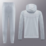 Light gray/blue tracksuit: hooded sweatshirt shown from the back with curved stitching and matching jogger pants displayed side by side.
