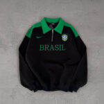 Black pullover sweatshirt with green collar and shoulders, BRASIL text across the chest and a Brazil crest on the left, plus a small Nike swoosh.