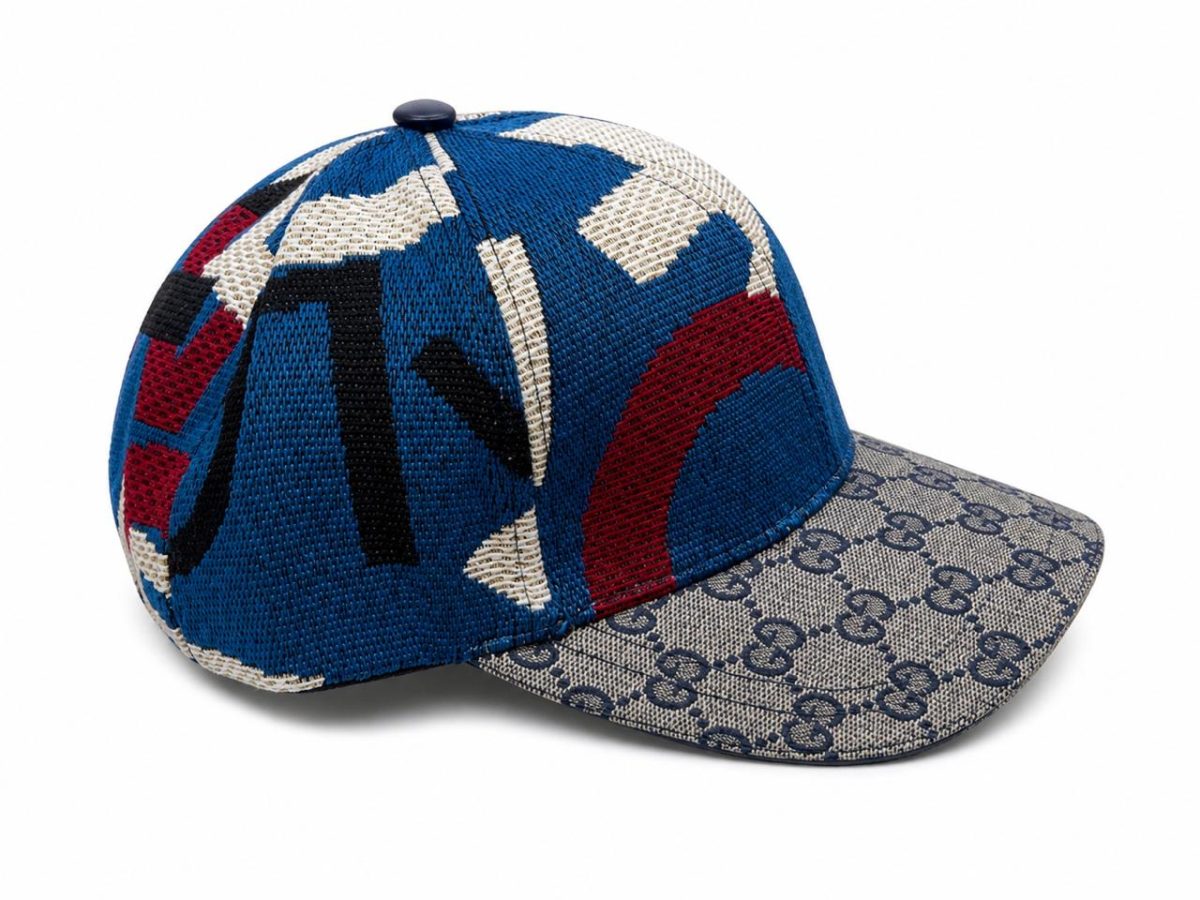 Blue and cream designer baseball cap with a knit crown and a GG monogrammed brim pattern on beige fabric.