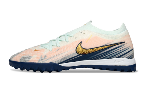 Nike soccer cleat with peach-to-light-teal gradient, gold Swoosh, white midsole, and dark blue studded outsole