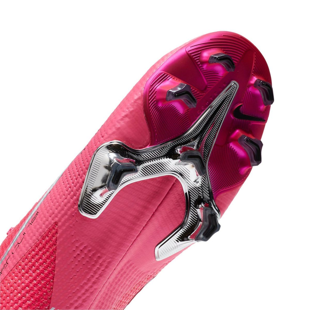 Close-up of a bright pink soccer cleat sole with metal plate and black studs