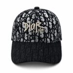 Dior baseball cap in black and gray with a repeating monogram pattern and gold 'DIOR PARIS' embroidery on the front crown.