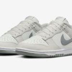 White Nike sneakers with a light gray swoosh and gray sole, low-top design.