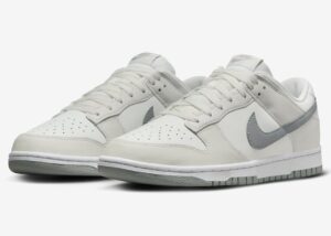 White Nike sneakers with a light gray swoosh and gray sole, low-top design.