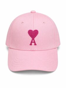 Pink baseball cap with a magenta ribbon heart embroidery on the front.