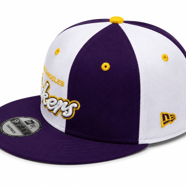 Purple and white Los Angeles Lakers snapback cap with yellow embroidery and New Era logo on the side, shown from a low angle.