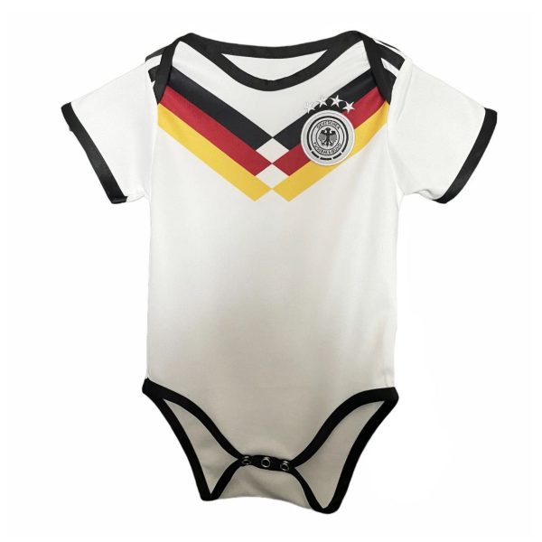 White baby onesie with black trim and German flag chevrons across the chest, and a circular German football badge.