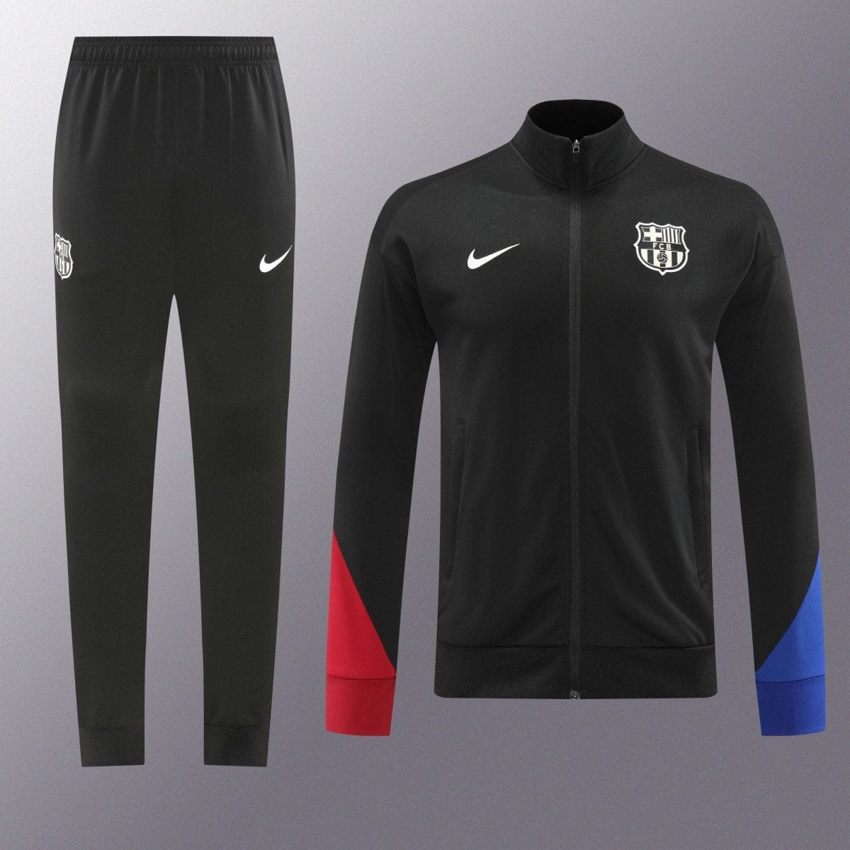 Black FC Barcelona tracksuit with a zip-up jacket, featuring the club crest on the chest and a white Nike swoosh; matching pants display the crest and logo.
