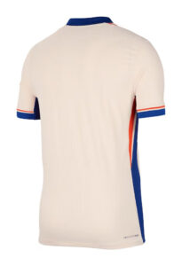 Beige sports jersey viewed from the back with blue collar and blue-trimmed sleeves, and blue side panels with red accents on the sides.
